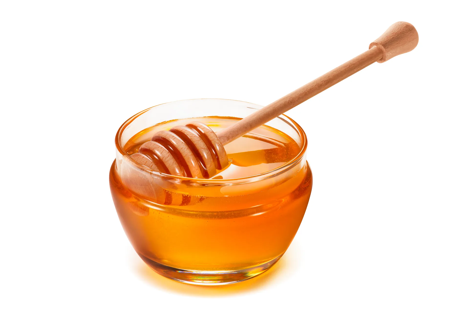 Un petit bol de verre contenant du miel